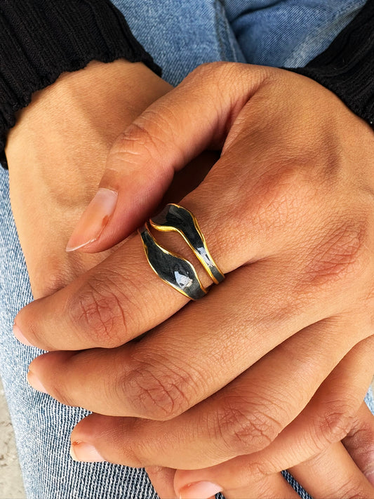 An 18k gold plated midnight pop open ring with a black inlay, displayed on a hand. Lilyah Jewelry Gold Plated Ring . Stunning, minimalistic, adjustable, elegant and statement ring. Gift idea for her.