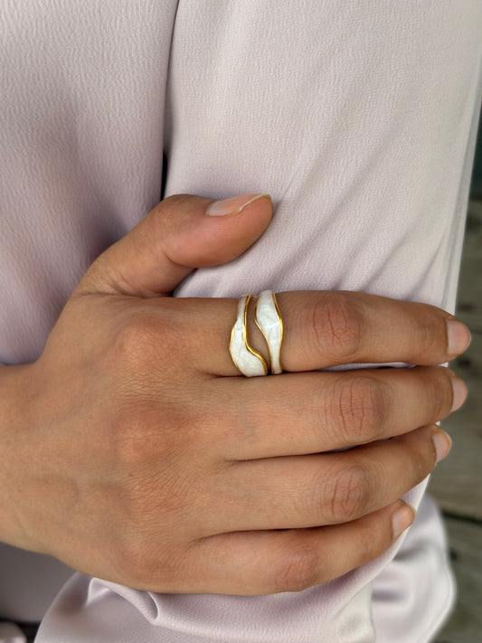An 18k gold plated midnight pop open ring with a white inlay, displayed on a finger. Lilyah Jewelry Gold Plated Ring . Stunning, minimalistic, adjustable, elegant and statement ring. Gift idea for her.