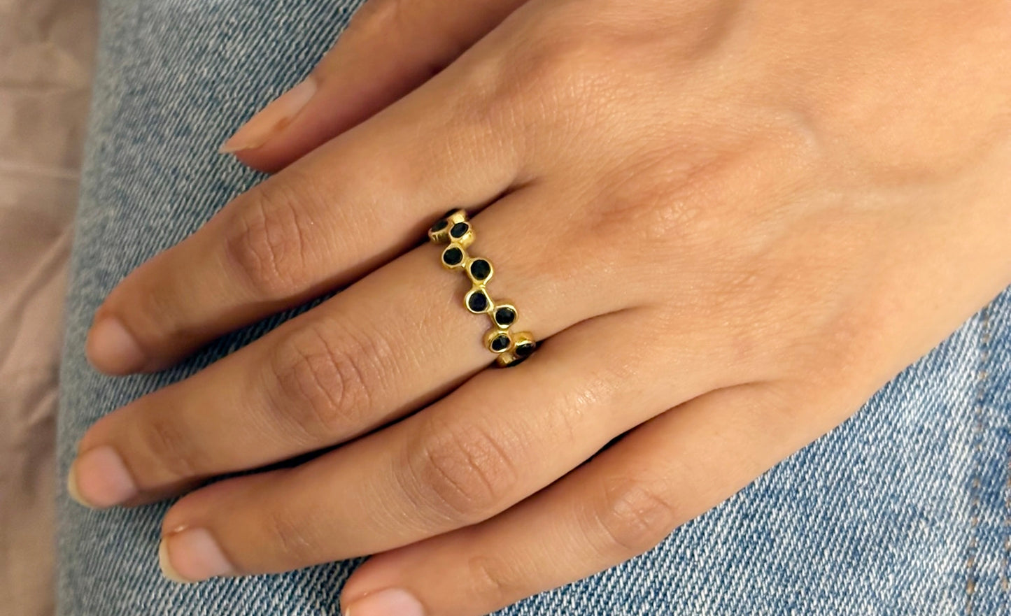 A person's hand wearing an 18k gold plated black modern mosaic open ring on the ring finger. Lilyah Jewelry Gold Plated Ring . Stunning, minimalistic, adjustable, elegant and statement ring. Gift idea for her.