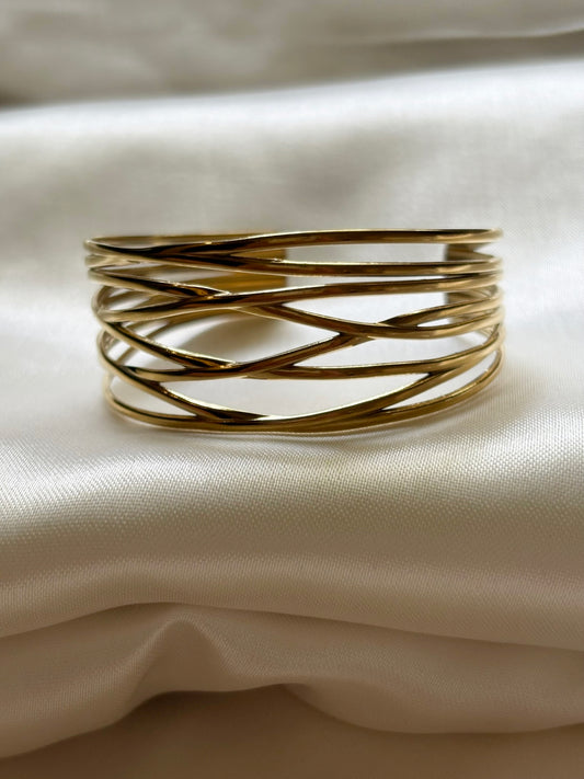 An 18k gold plated openwork cuff bracelet displayed on a white surface. Lilyah Jewelry Gold Plated Delicate Bracelet . Stunning and elegant. Gift idea for her