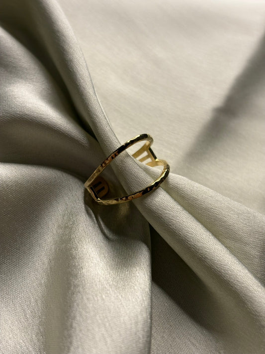 Gold ring with a black band on a light fabric background. Lilyah Jewelry Gold Plated Ring . Stunning, minimalistic, adjustable, elegant and statement ring. Gift idea for her.