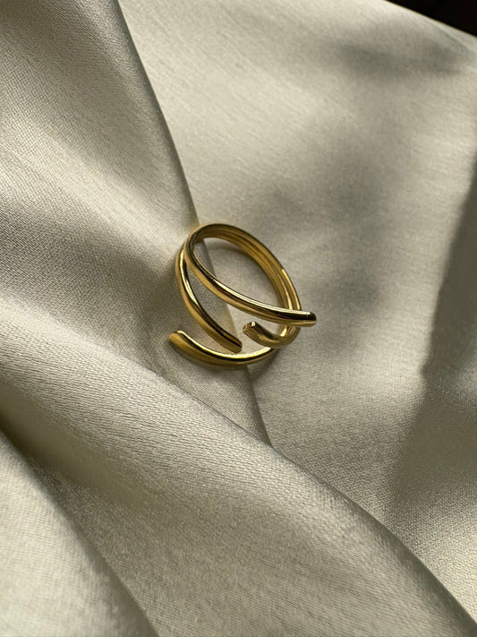 Gold ring on a light fabric background. Lilyah Jewelry Gold Plated Ring . Stunning, minimalistic, adjustable, elegant and statement ring. Gift idea for her.