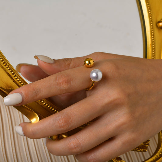 A person's hand showcasing a gold-plated ring with a pearl inlay on the finger. Lilyah Jewelry Gold Plated Ring . Stunning, minimalistic, adjustable, elegant and statement ring. Gift idea for her.