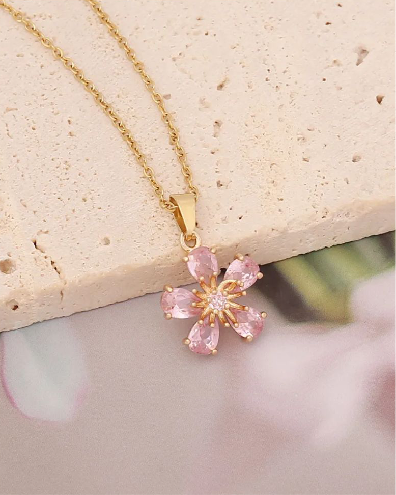 Lilyah Jewelry Gold Plated Zircon Diamond Necklace. Gold plated necklace with a pink flower pendant on a light background