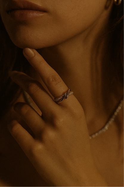 Lilyah Jewelry Gold Plated Zircon Diamond Ring. adjustable promise ring. accents of gold and diamonds. Close-up of a hand with a ring on a blurred background