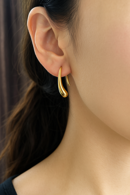 A close-up image of a woman's ear wearing a gold-plated hoop earring. Lilyah Jewelry Gold Plated Earring. Gift Ideas for her.