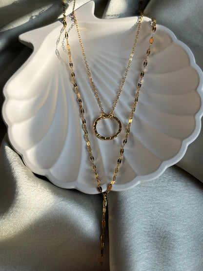 Lilyah Jewelry Gold Plated necklaces on a shell-shaped jewelry dish with a light gray background