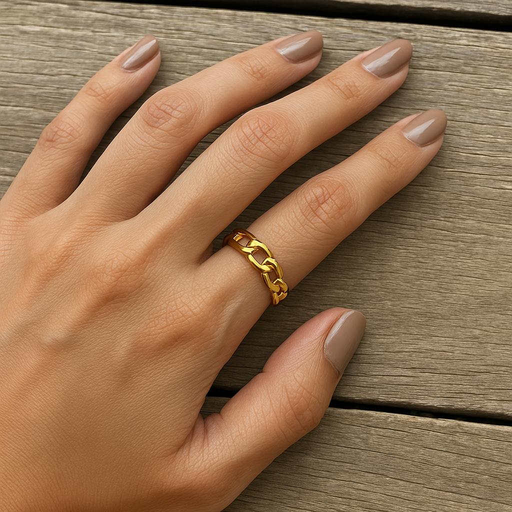 A gold-plated chain link open ring on a person's hand, with the ring's adjustable band visible. Lilyah Jewelry Gold Plated Ring . Stunning, minimalistic, adjustable, elegant and statement ring. Gift idea for her.