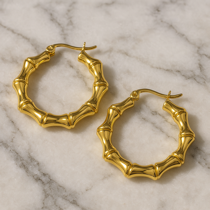 A pair of 18k gold plated textured bamboo hoop earrings placed on a marble surface. Lilyah Jewelry Gold Plated Earring. Gift Ideas for her.