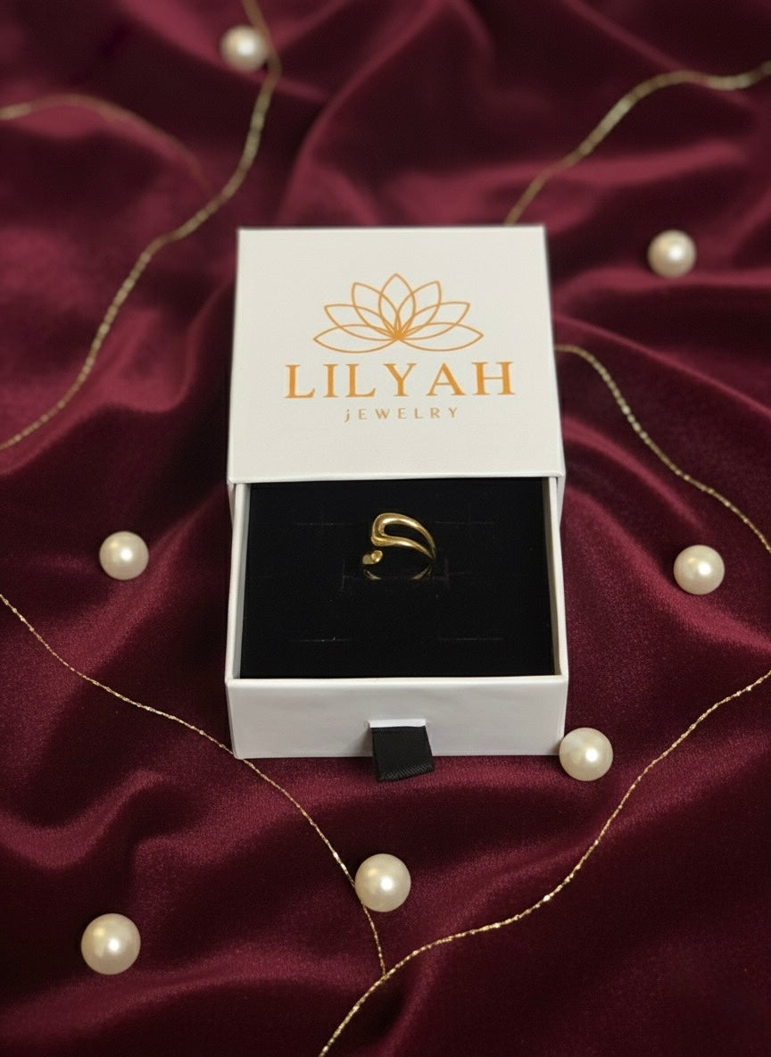 Gold ring in a LILYAH jewelry box on a burgundy fabric background with pearls. Lilyah Jewelry Gold Plated Ring . Stunning, minimalistic, adjustable, elegant and statement ring. Gift idea for her.