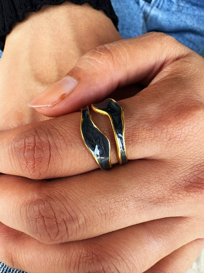 An 18k gold plated midnight pop open ring with a black inlay, displayed on a hand. Lilyah Jewelry Gold Plated Ring . Stunning, minimalistic, adjustable, elegant and statement ring. Gift idea for her.