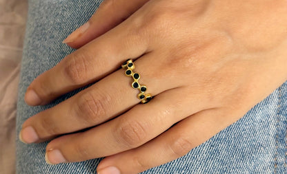 A person's hand wearing an 18k gold plated black modern mosaic open ring on the ring finger. Lilyah Jewelry Gold Plated Ring . Stunning, minimalistic, adjustable, elegant and statement ring. Gift idea for her.