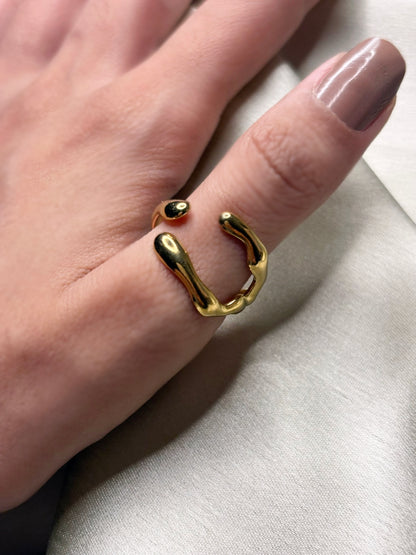 Gold ring on a finger with a neutral background. Lilyah Jewelry Gold Plated Ring . Stunning, minimalistic, adjustable, elegant and statement ring. Gift idea for her.
