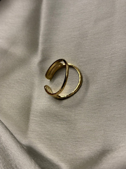 Gold open ring on a light gray fabric background. Lilyah Jewelry Gold Plated Ring . Stunning, minimalistic, adjustable, elegant and statement ring. Gift idea for her.