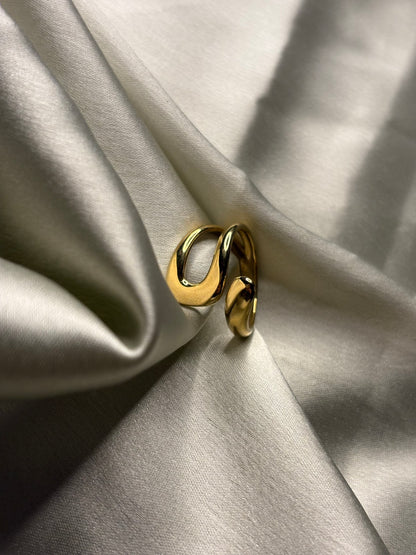 Gold ring on a light fabric background Lilyah Jewelry Gold Plated Ring . Stunning, minimalistic, adjustable, elegant and statement ring. Gift idea for her.