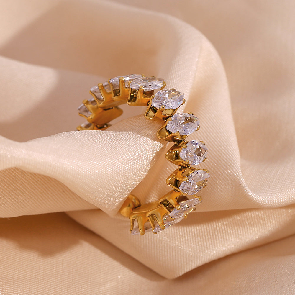 Lilyah Jewelry Gold Plated Zircon Diamond Adjustable Ring. Gold ring with clear gemstones on a beige fabric background