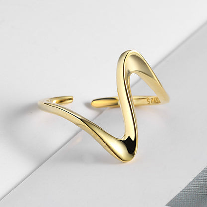 A gold-plated wave ring with an adjustable band, placed on a white surface. Lilyah Jewelry Gold Plated Ring . Stunning, minimalistic, adjustable, elegant and statement ring. Gift idea for her.