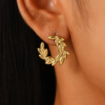 A close-up image of a woman's ear wearing a gold-plated leaf hoop earring. Lilyah Jewelry Gold Plated Earring. Gift Ideas for her.