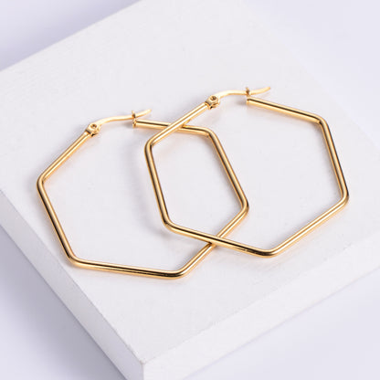 A pair of 18k gold plated hexagon hoop earrings placed on a white surface. Lilyah Jewelry Gold Plated Earring. Gift Ideas for her.