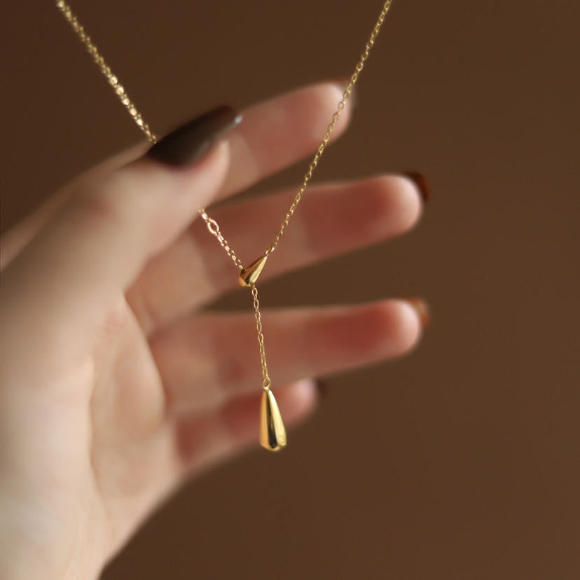 Lilyah Jewelry Gold Plated Necklace. Gift Ideas for her. A woman is about to hold the necklace in her hand.